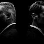 Black and white profiles of two men facing away.