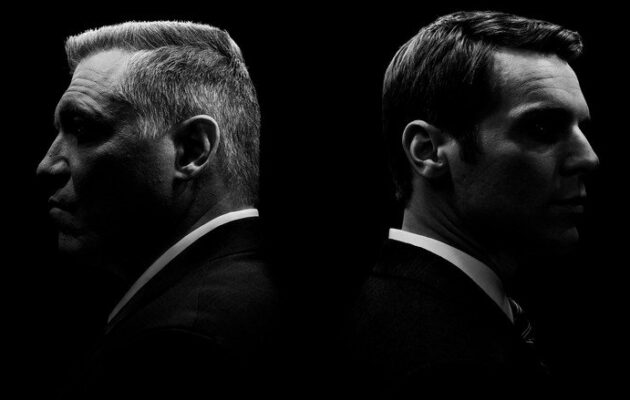 Black and white profiles of two men facing away.